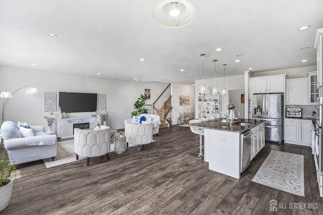18 Larkspur Ln, Monroe, NJ 08831 - kitchen featuring stainless steel appliances, open floor plan, a breakfast bar, dark wood-style flooring, and white cabinets