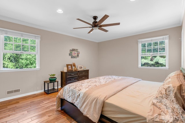 bedroom featuring light wood-style flooring, ornamental molding, baseboards, recessed lighting, and ceiling fan