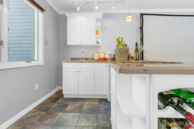 kitchen with open shelves, baseboards, white cabinetry, crown molding, and pendant lighting