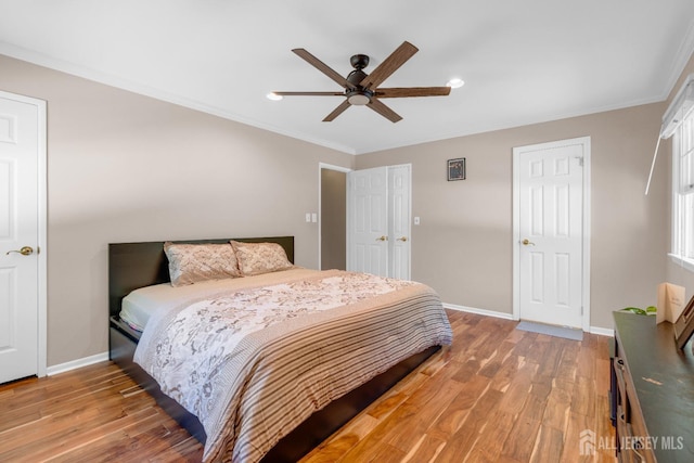 bedroom with light wood finished floors, baseboards, crown molding, recessed lighting, and a ceiling fan