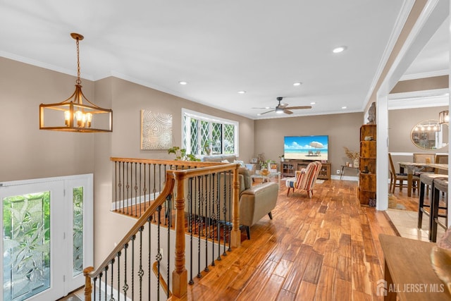 living room with a chandelier, light wood finished floors, recessed lighting, a ceiling fan, and ornamental molding