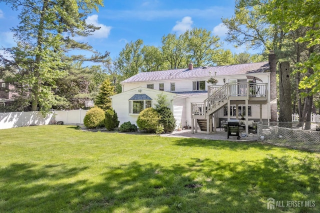 back of house featuring a patio area, a wooden deck, stairway, and a chimney