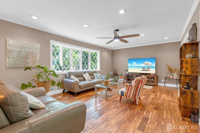 living area featuring light wood-style flooring, a ceiling fan, recessed lighting, crown molding, and baseboards