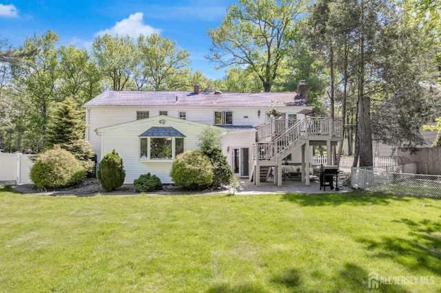 back of house featuring stairs, a wooden deck, a patio, and a chimney