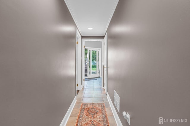 hallway with crown molding, baseboards, recessed lighting, and light tile patterned floors