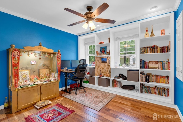 office area with crown molding, a ceiling fan, and wood finished floors