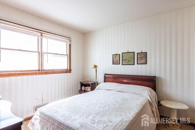 bedroom with a baseboard heating unit