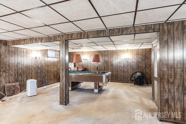 rec room featuring concrete floors, a paneled ceiling, wood walls, and pool table