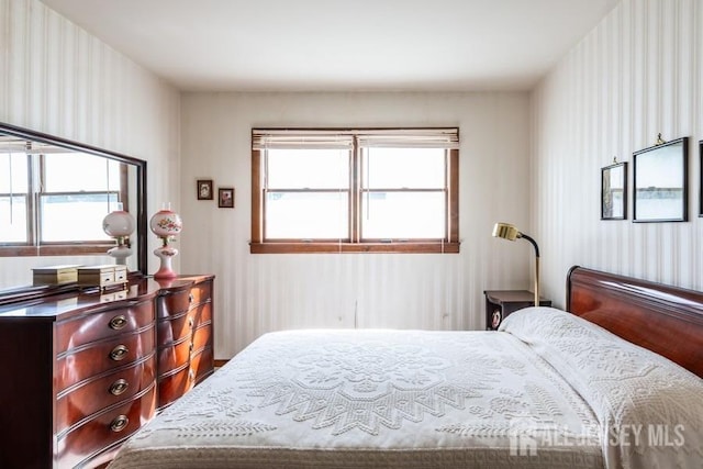 bedroom with wallpapered walls