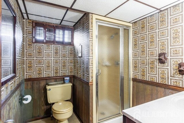 full bath with toilet and a stall shower