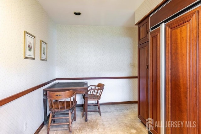 office space featuring wallpapered walls and light floors