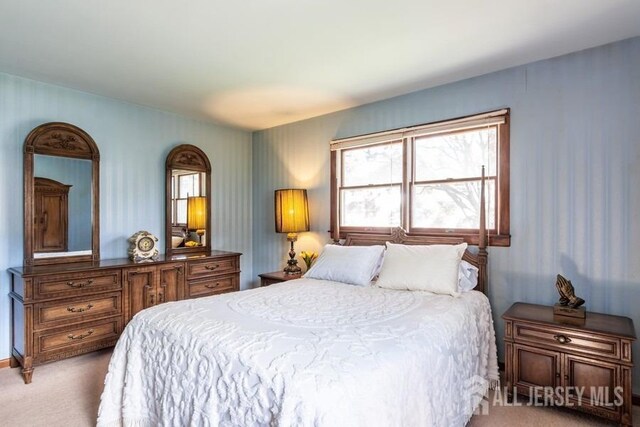 carpeted bedroom featuring wallpapered walls