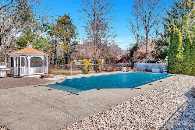 view of swimming pool with a gazebo, fence, and a patio