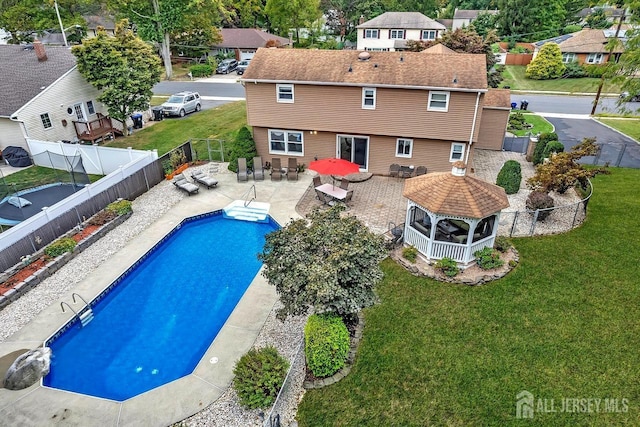 view of swimming pool with a gazebo and a residential view