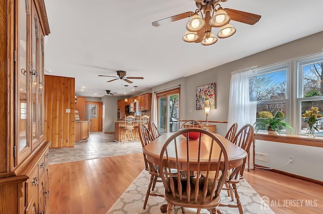 dining area with a ceiling fan, light wood finished floors, baseboards, and recessed lighting