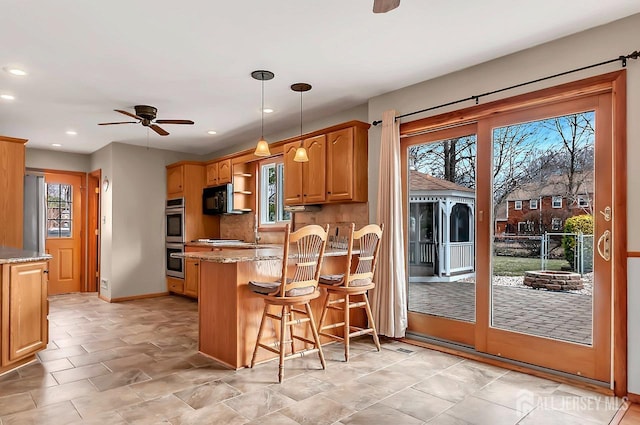 kitchen featuring ceiling fan, light stone counters, a peninsula, black microwave, and recessed lighting