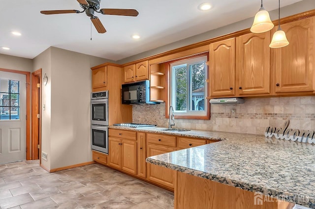 kitchen with a sink, stainless steel appliances, baseboards, tasteful backsplash, and a ceiling fan