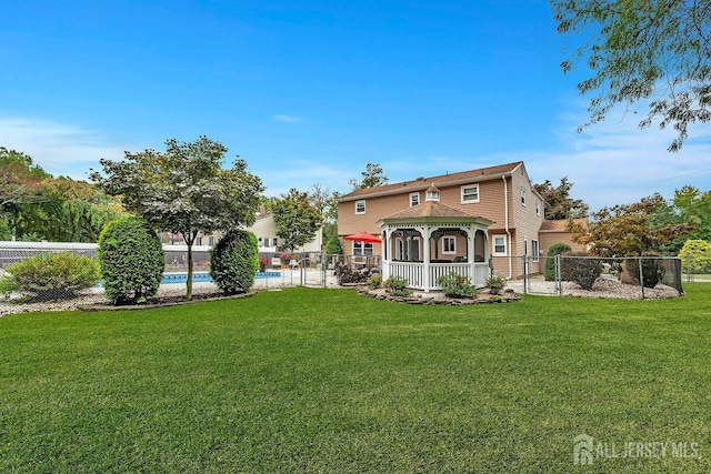 back of property with a gazebo