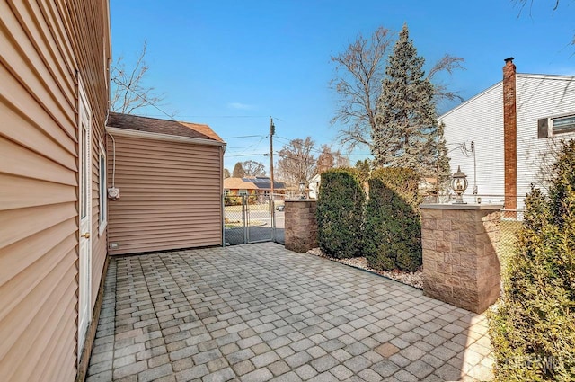 view of patio with a gate and fence