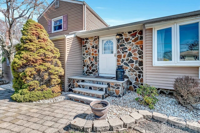 doorway to property with stone siding