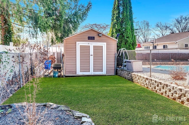 view of shed featuring a fenced in pool and a fenced backyard