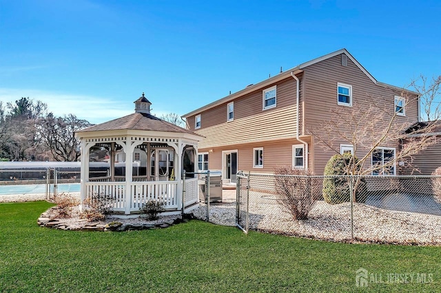 back of property with a gazebo