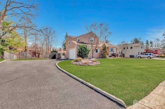 view of front of house featuring driveway, a gate, and an attached garage