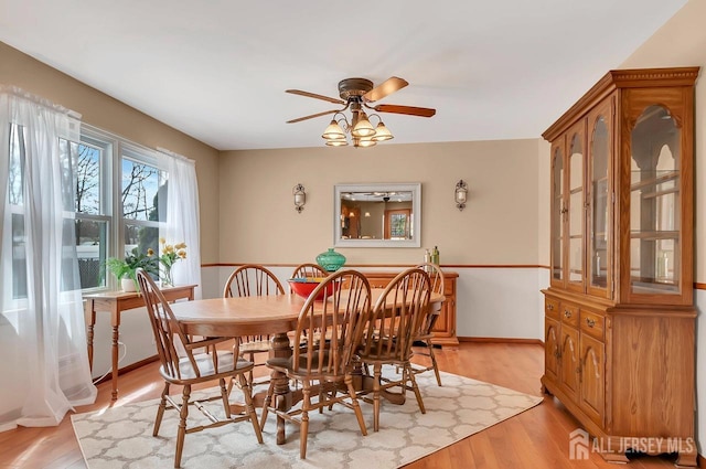dining area featuring ceiling fan and light wood-style floors