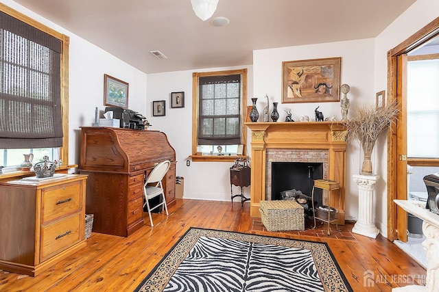 234 W Church St, Gloucester Twp, NJ 08012 - sitting room with wood-type flooring, healthy amount of natural light, and a brick fireplace