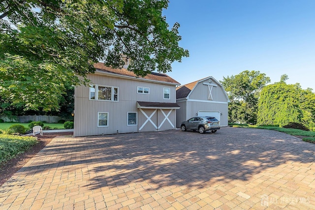 234 W Church St, Gloucester Twp, NJ 08012 - view of front of home featuring a barn, a garage, and a chimney