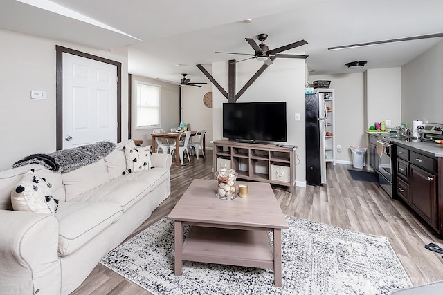234 W Church St, Gloucester Twp, NJ 08012 - living room featuring baseboards, a ceiling fan, and light wood finished floors