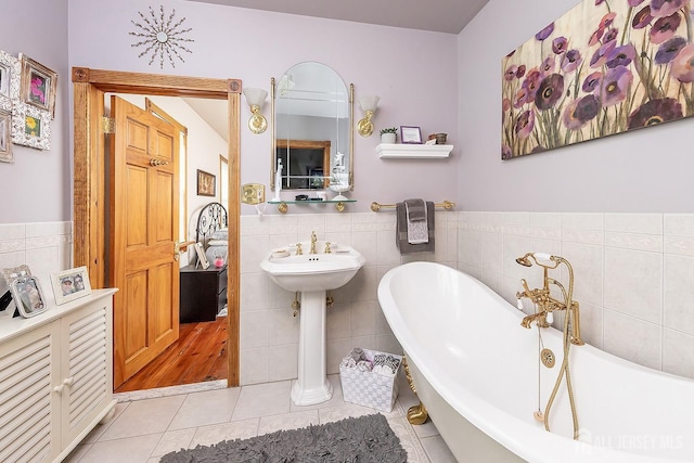 234 W Church St, Gloucester Twp, NJ 08012 - full bath featuring tile patterned flooring, a freestanding tub, wainscoting, and tile walls