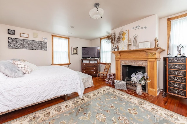 234 W Church St, Gloucester Twp, NJ 08012 - bedroom featuring a brick fireplace, multiple windows, and wood finished floors