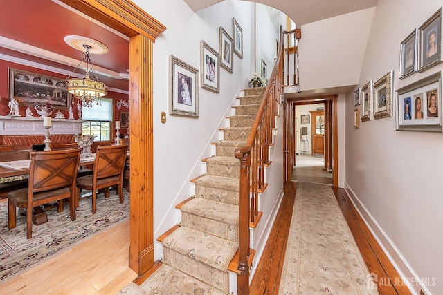 234 W Church St, Gloucester Twp, NJ 08012 - stairs featuring baseboards, a notable chandelier, and wood finished floors