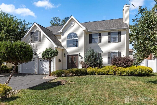 view of front of home featuring a garage and a front lawn