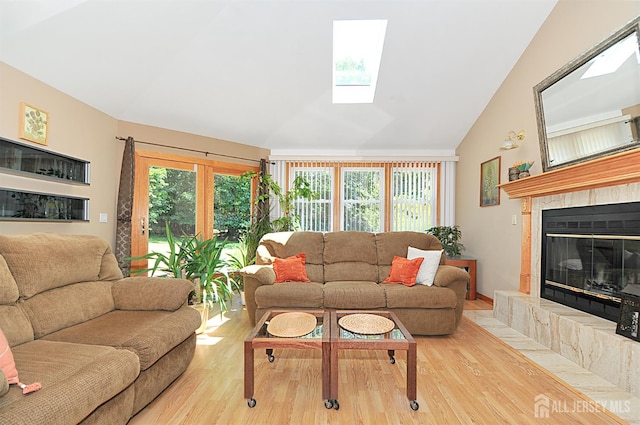 1329 Crown Ln, South Plainfield, NJ 07080 - living room featuring wood finished floors, lofted ceiling, a tiled fireplace, and a skylight