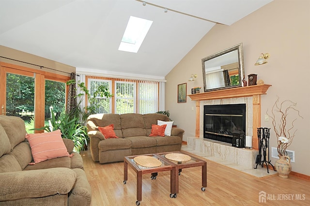 1329 Crown Ln, South Plainfield, NJ 07080 - living area featuring a skylight, wood finished floors, vaulted ceiling, and a fireplace