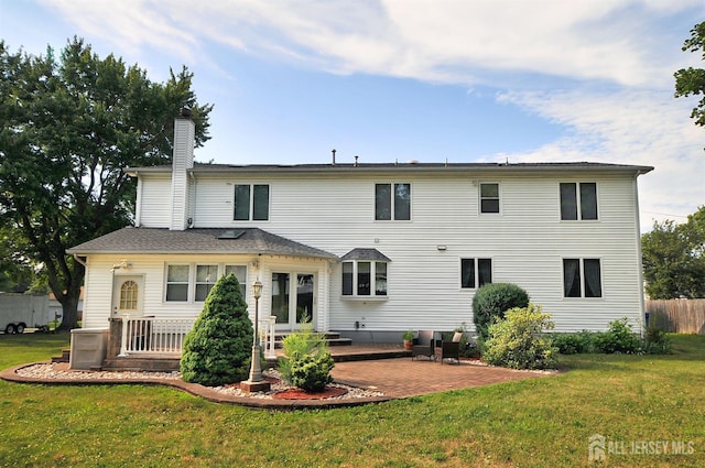 1329 Crown Ln, South Plainfield, NJ 07080 - rear view of property with a chimney, a patio area, and a yard