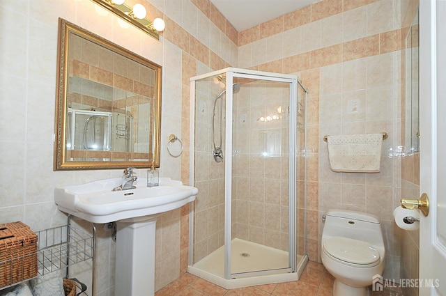 1329 Crown Ln, South Plainfield, NJ 07080 - bathroom with tile walls, a stall shower, and tile patterned floors