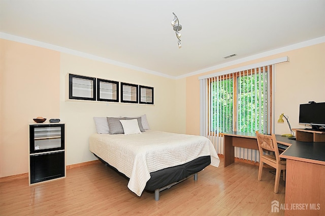 1329 Crown Ln, South Plainfield, NJ 07080 - bedroom with crown molding, light wood-style floors, and an office area