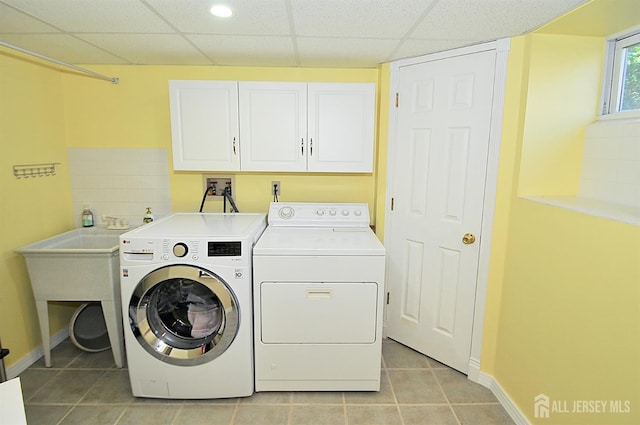 1329 Crown Ln, South Plainfield, NJ 07080 - washroom featuring cabinet space, washing machine and dryer, and light tile patterned floors