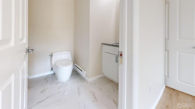 bathroom featuring a baseboard radiator, vanity, and toilet