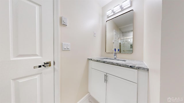 bathroom with vanity and a shower