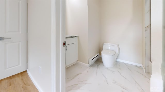 bathroom with vanity, toilet, and baseboard heating