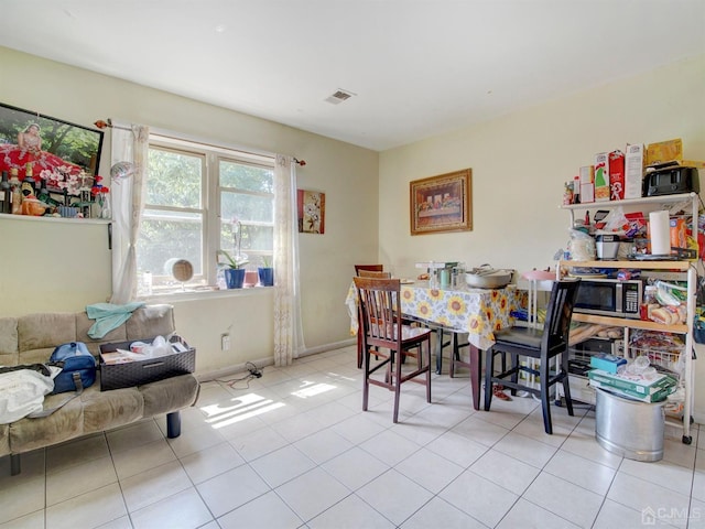 dining space featuring light tile patterned floors