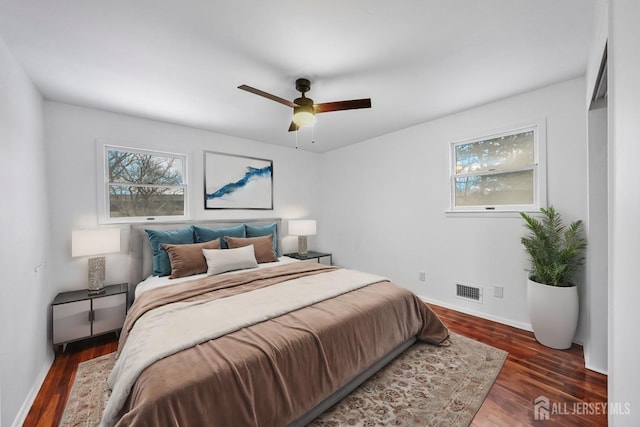 bedroom with dark hardwood / wood-style floors and ceiling fan