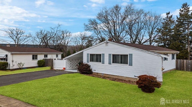 ranch-style house with a carport and a front lawn