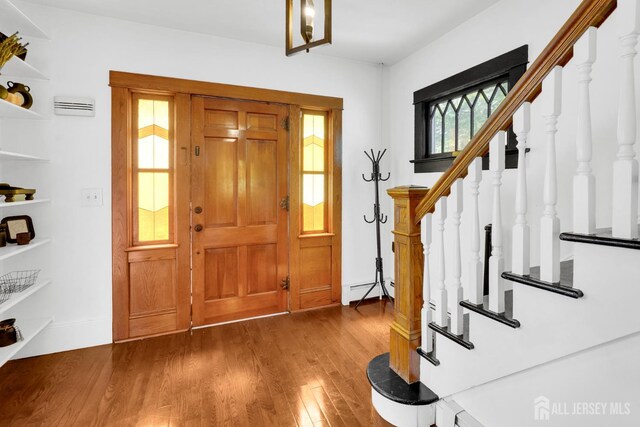 369 N Main St, Milltown, NJ 08850 - entrance foyer featuring stairway, wood finished floors, and a baseboard radiator