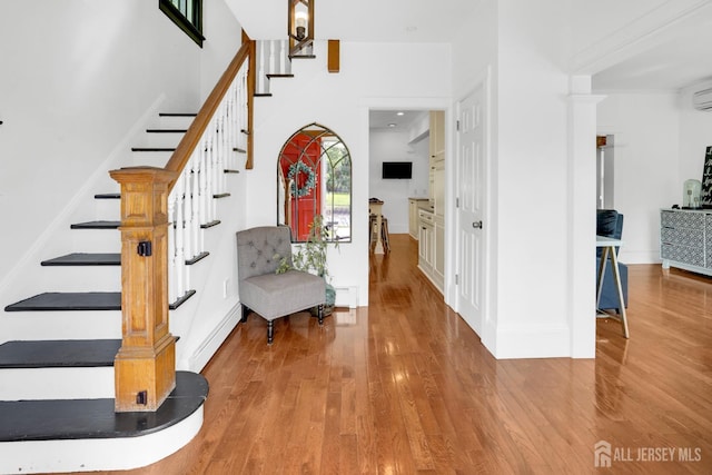 369 N Main St, Milltown, NJ 08850 - foyer with wood finished floors, stairs, and a wall mounted air conditioner
