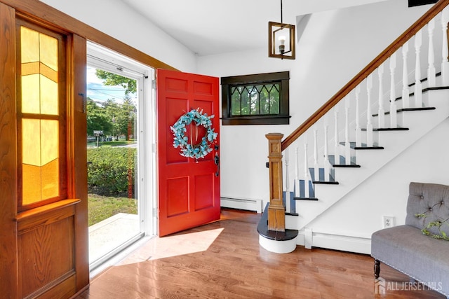 369 N Main St, Milltown, NJ 08850 - foyer featuring baseboard heating, wood finished floors, and stairs
